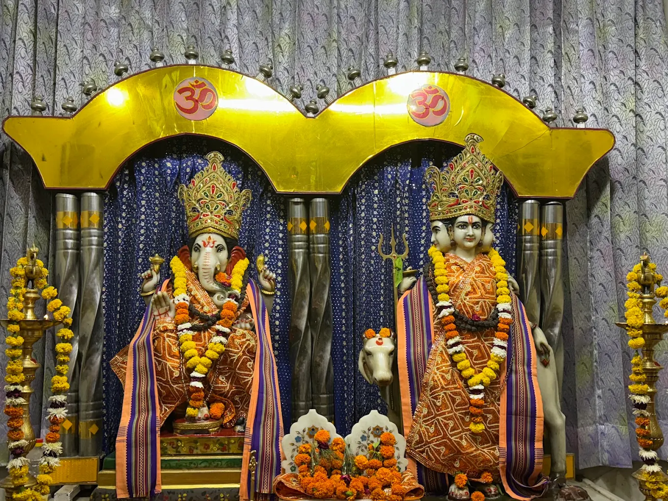 Deities in festive attire at the Mandir