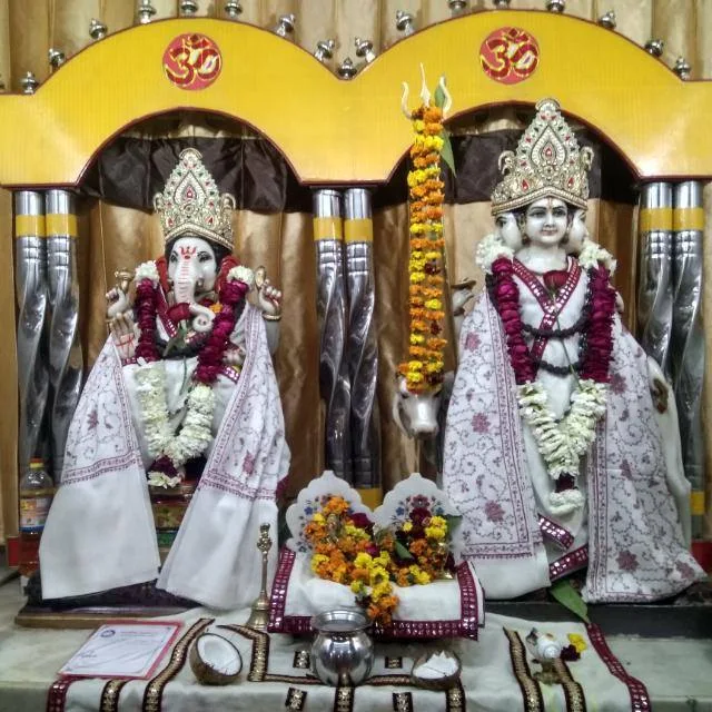 Deities in white ceremonial attire